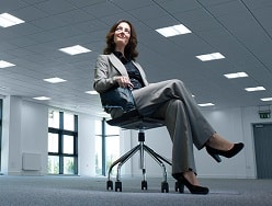 business woman sitting in desk chair